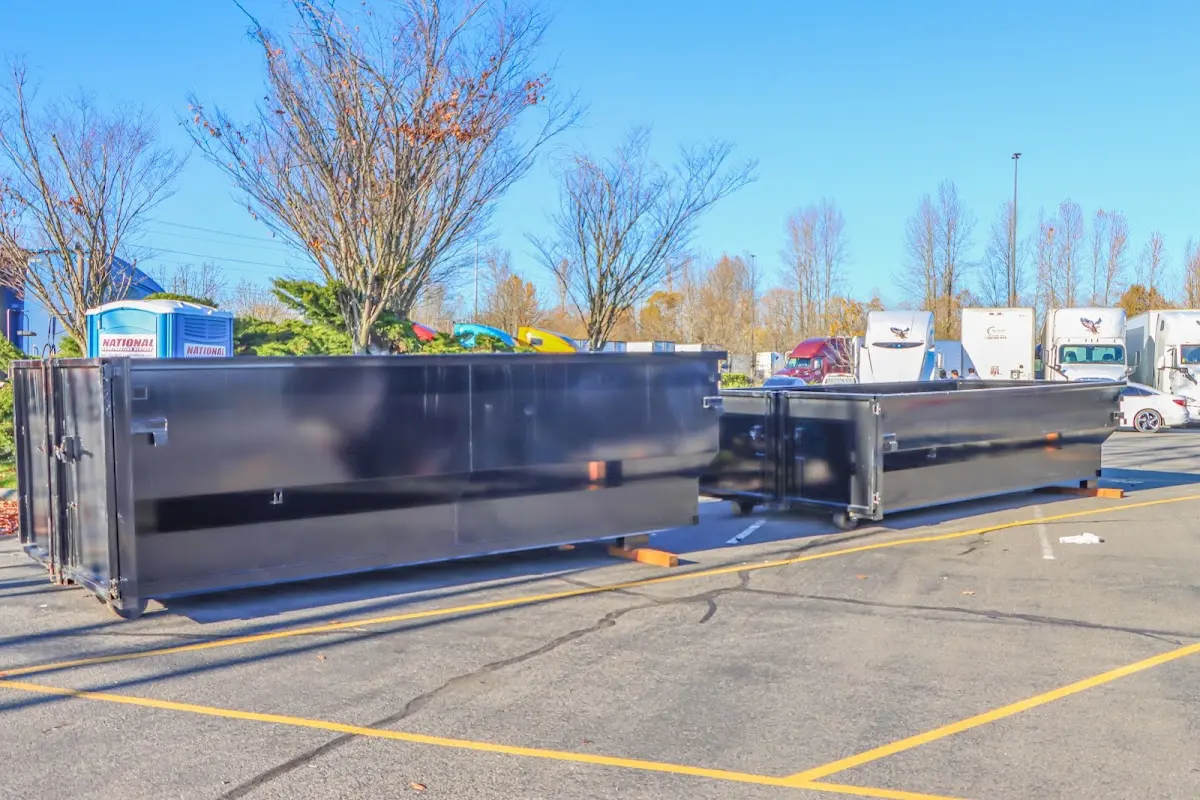 Professional dumpster rental service with roll-off container on residential driveway in Shafter